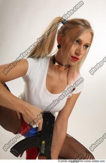 Nikol Squatting Pose With Gun